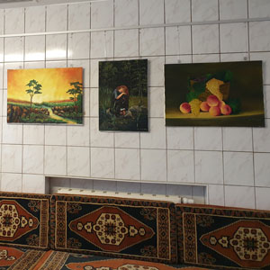 Drei Gemälde einer Ausstellung in Ladenumgebung