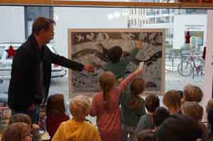René Kaufmann mit Kita-Kindern bei der Öffnung des 1. Kalendertürchens in der Bibliothek Pieschen, Quelle: Freidrich Hausen